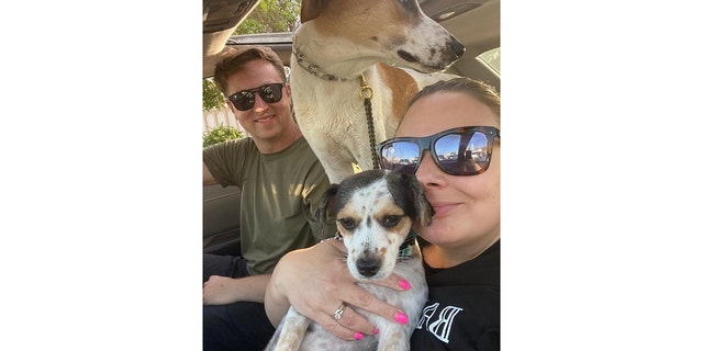 U.S. Navy Chief Petty Officer Matt Johnson and Navy veteran Coreen Johnson are shown in a selfie with Ruby and Sunny.